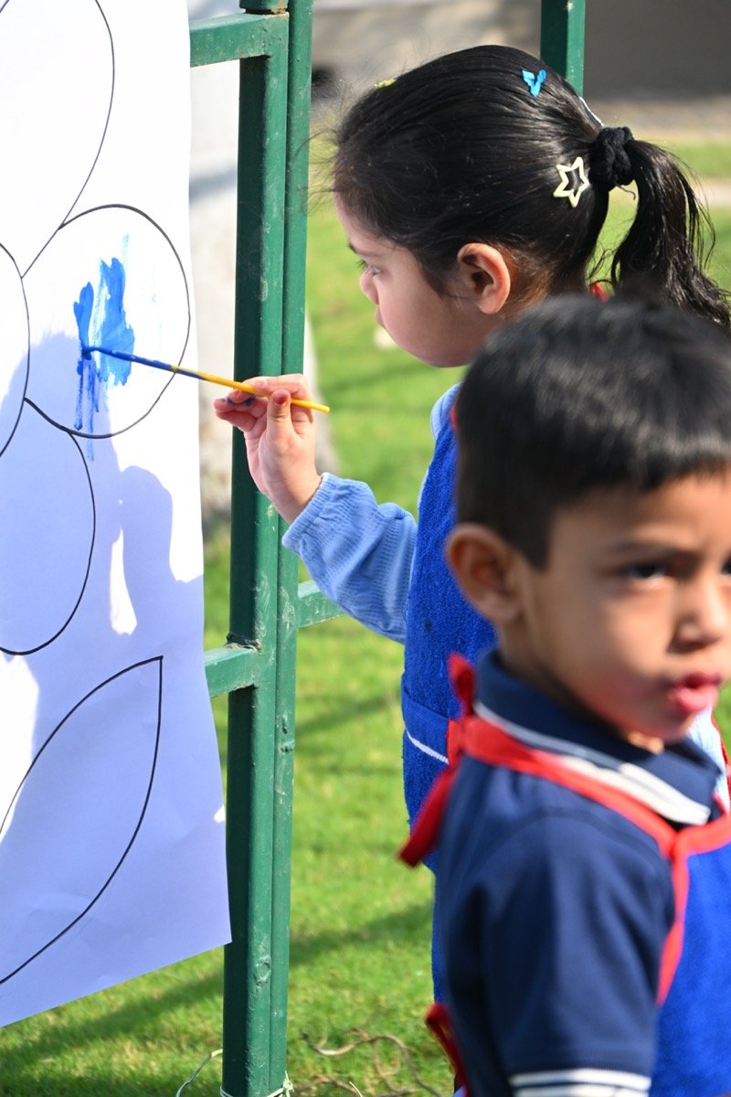 Toddlers painting in a classroom
